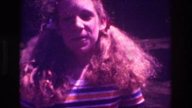 1981: A Girl with Red Curly Hair and Pigtails Smiling and Talking