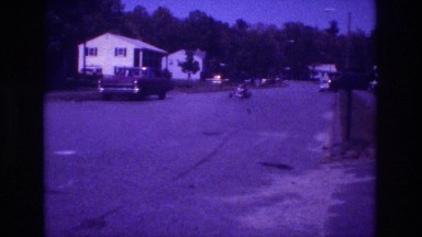 1981: an open car is driven by children along the road in a village SAN DIEGO