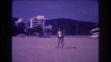 1982: Adventurous Woman Preparing to Go Paragliding at Tropical Beach Resort