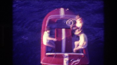 1982: three people riding in a small red boat ACAPULCO MEXICO