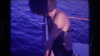 1982: a woman on a boat looking down at scuba divers in the water ACAPULCO