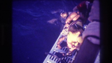 1982: seawater man diving mask wearing safety equipment people standing watching