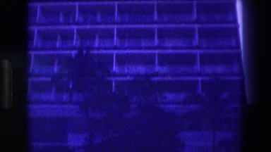 1982: camera span from building down to a girl at pool area
