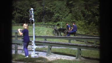 1975: park people walking jogging playing sliding greenery trees around