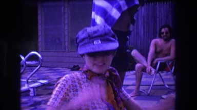 1975: swim suit sitting man woman posing swimming pool side BOSTON