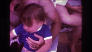 1975: topless father holding child outdoor happy BOSTON