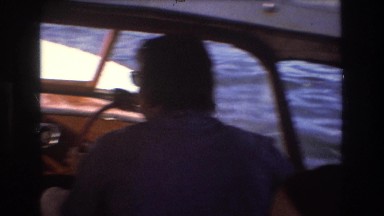 1975: viewing of people on a motorboat out on the lake. BOSTON