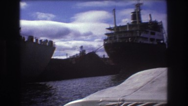 1975: merchant ships in shipping lanes along the dock. BOSTON