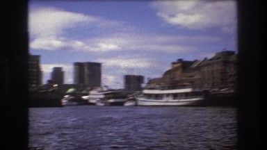 1975: amazing view of a large city with skyscrapers on the shore of lake BOSTON