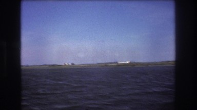 1975: from the ocean view, watching an airplane takeoff. BOSTON