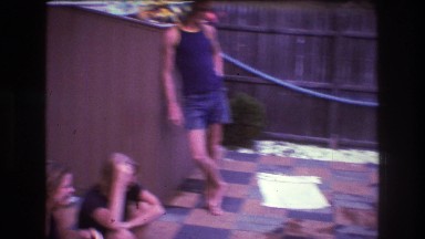 1975: teenagers lounge around a backyard swimming pool