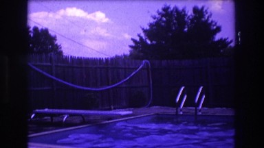 1975: family all relaxing by the swimming pool. BOSTON