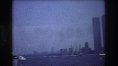 1976: a panorama of new york city harbor, filled with boats, with the twins
