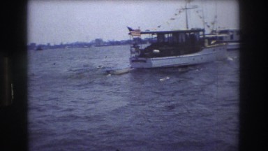 1976: small boat cruising powering through harbor pennants marine ocean NEW YORK