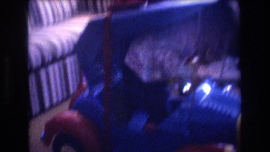 1975: small kid playing with his new toy plastic car. BAXTER MAINE