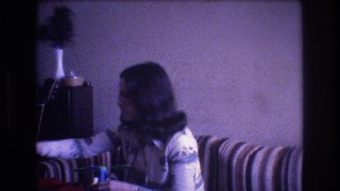 1975: woman sitting indoor playing with a toy BAXTER MAINE