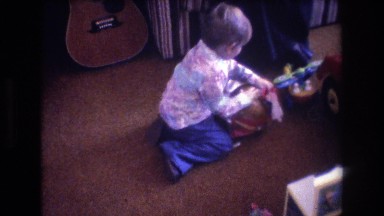1975: little kid opening a gift. BAXTER MAINE