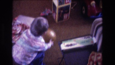 1975: little kid playing with a toy ball. BAXTER MAINE