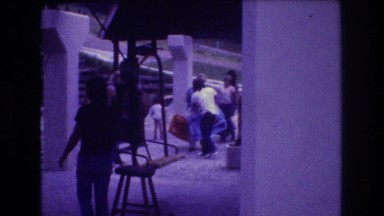 1976: a young man in a tee shirt works as a chair lift operator at a ski area.