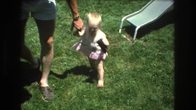 1976: a beautiful baby girl is walking in the park with dad for the first time.