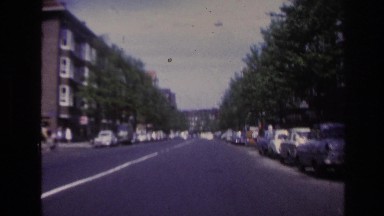 1967: view from inside a car driving down an empty city street