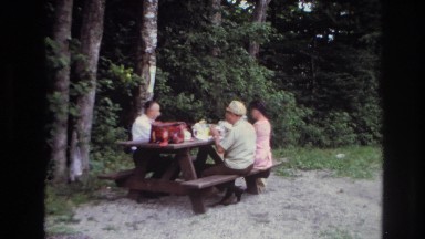 1967: three people eat at a picnic table near trees OTTAWA CANADA