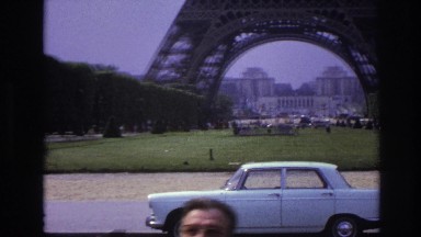 1967: the beautiful eiffel tower in paris, france under a very cloudy blue sky