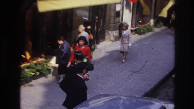 1967: a busy street, a woman walking down the street looks like she's in a hurry