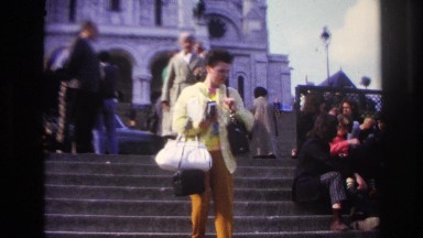 1967: woman walking down the steps of a busy public area. PARIS FRANCE