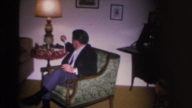 1966: friend gathering having small party drinking sitting on sofa