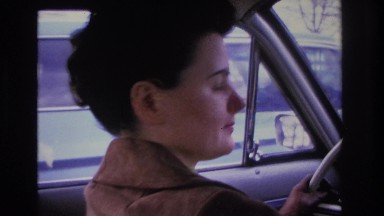 1966: woman driving smiles at camera HOBOKEN NEW JERSEY