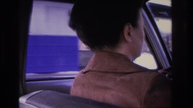 1966: Woman Driving Car Stops at Toll to Make Payment