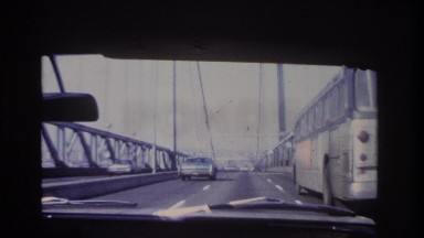 1966: cars, buses and other vehicles are moving through a bridge on the highway