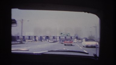 1966: various cars lined up at a checkpoint with a green sign. HOBOKEN