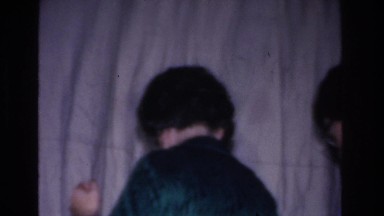 1966: middle aged woman in green dress adjusting santa figure HOBOKEN NEW JERSEY