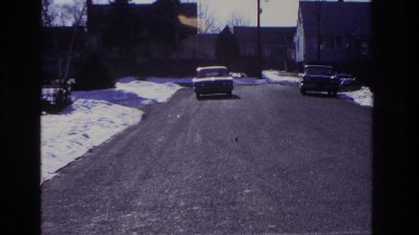 1966: the man drives his car slowly down the icy road. HOBOKEN NEW JERSEY