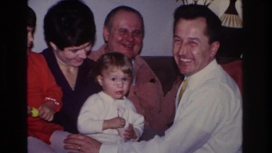 1966: men women and children seated on couch laughing playing smoking HOBOKEN