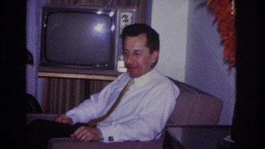 1966: man sitting by tv when daughter sits on his lap HOBOKEN NEW JERSEY
