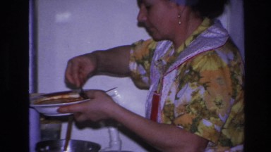 1966: woman standing by the stove, cooking. HOBOKEN NEW JERSEY