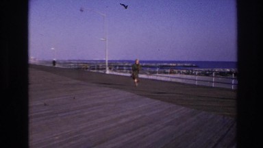1966: vintage video of woman walking on boardwalk on a cool day HOBOKEN