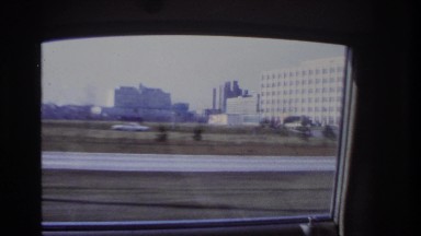 1966: car driving past a city HOBOKEN NEW JERSEY