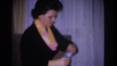 1966: Woman Unwrapping Christmas Present in Hoboken, New Jersey