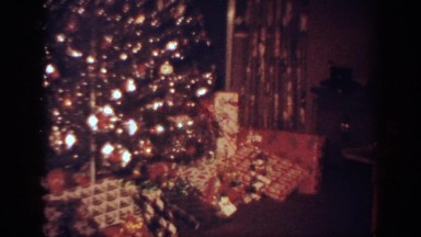 1962: a livingroom decorated with a christmas tree and decorations
