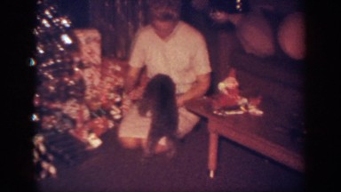1962: a woman is holding her dog under the christmas tree BLAINSPORT
