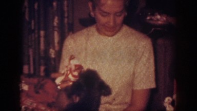 1962: woman playing with a dog on christmas BLAINSPORT PENNSYLVANIA