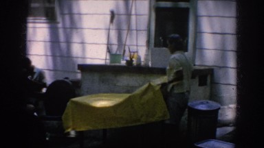 1962: adult removing plastic cover while another adult cleans BLAINSPORT