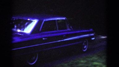 1962: aristocratic sedan of black color is reaching the house with cute premises
