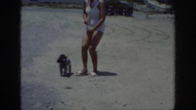 1962: two women walking their little poodles in the sand RALEIGH NORTH CAROLINA