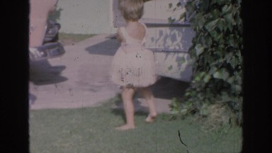 1967: two adorable girls are dancing in cute outfits in the yard