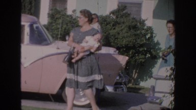 1967: happy adults, delighted children, outdoors, a brown car